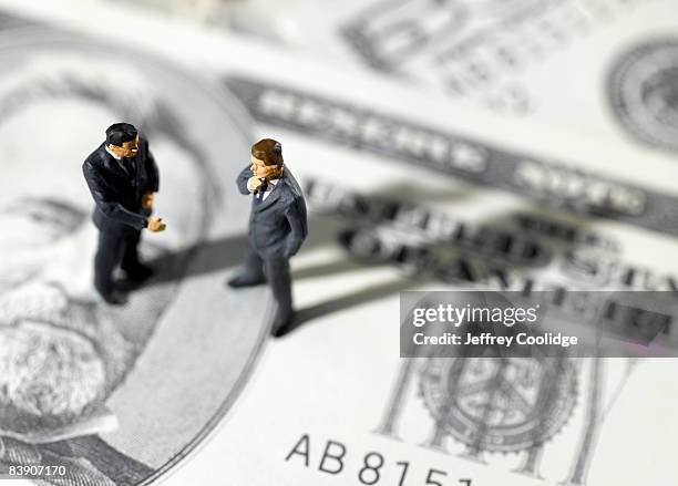 toy businessmen on us paper currency - figurine stock pictures, royalty-free photos & images