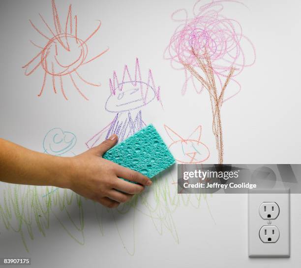 hand cleaning off child's drawing - cleaning sponge stock pictures, royalty-free photos & images