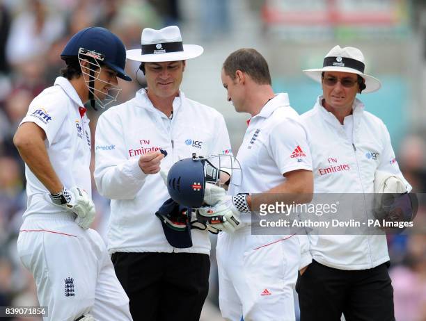 Umpire Simon Taufel hands England's Andrew Strauss a piece of his broken visor after Strauss was struck on the helmet during the npower Fourth Test...