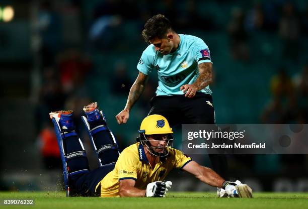 Colin de Grandhomme of Birmingham dives to make his ground as Jade Dernbach of Surrey attempts to run him out during the NatWest T20 Blast...