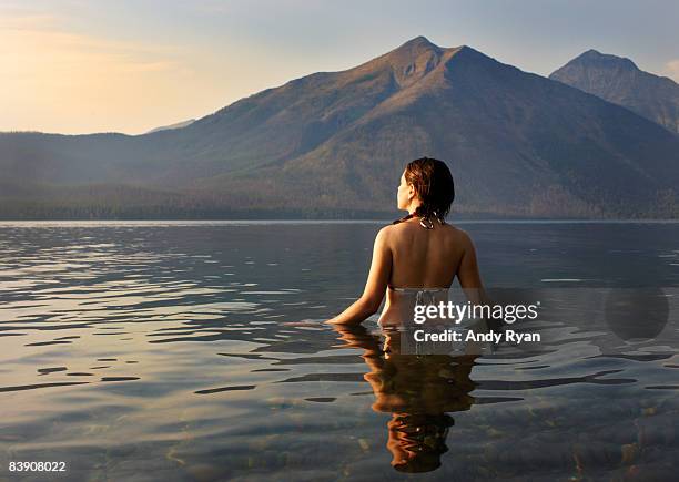 woman wading in lake - wonderlust2015 stock pictures, royalty-free photos & images