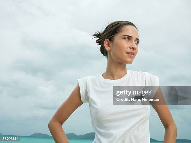 woman in a white tee at the beach - camiseta fotografías e imágenes de stock