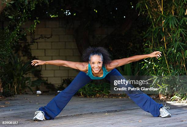 mature woman stretching - legs spread woman stock pictures, royalty-free photos & images