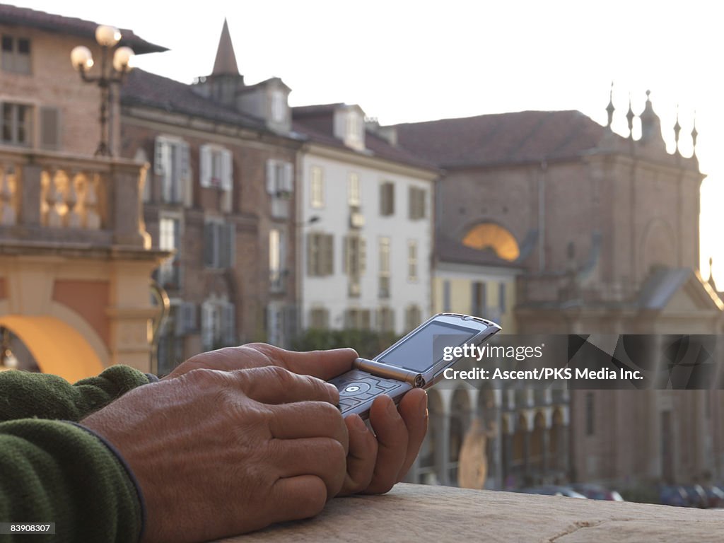Detail of man text messaging in medieval setting