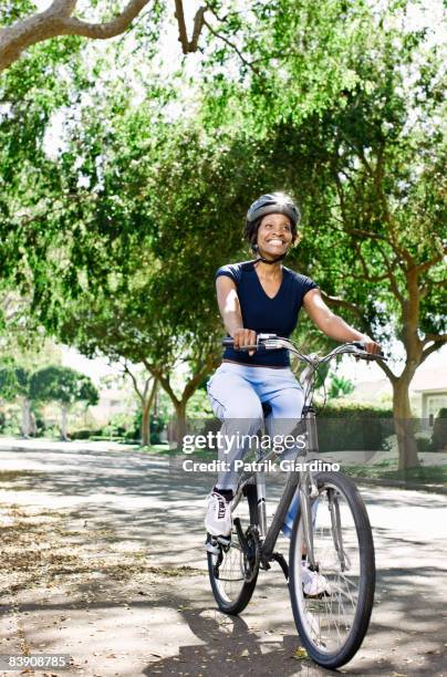 mature woman fitness - black woman riding bike stock pictures, royalty-free photos & images