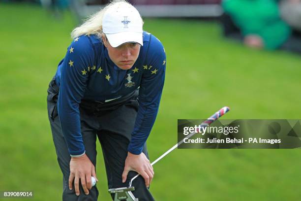 Europe's Suzann Pettersen studies her match winning putt against USA's Michelle Wie during day three of the 2011 Solheim Cup at Killeen Castle,...