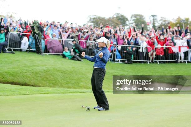 Europe's Suzann Pettersen celebrates after winning her singles match against USA's Michelle Wie with a putt on the 18th during day three of the 2011...