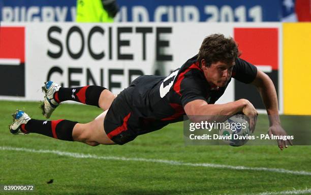 Wales' Lloyd Williams dives over the line for a try