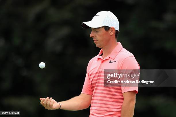 Rory McIlroy of Northern Ireland tosses a ball on the ninth hole during round two of The Northern Trust at Glen Oaks Club on August 25, 2017 in...