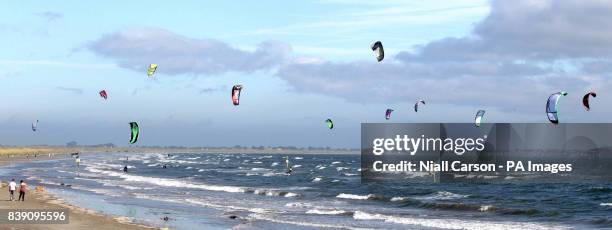 Kite surfers are seen on Dollymount strand in Dublin, as the unseasonably warm weather continues.