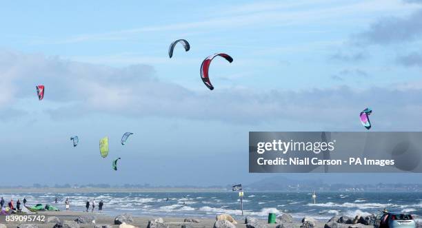 Kite surfers are seen on Dollymount strand in Dublin, as the unseasonably warm weather continues.