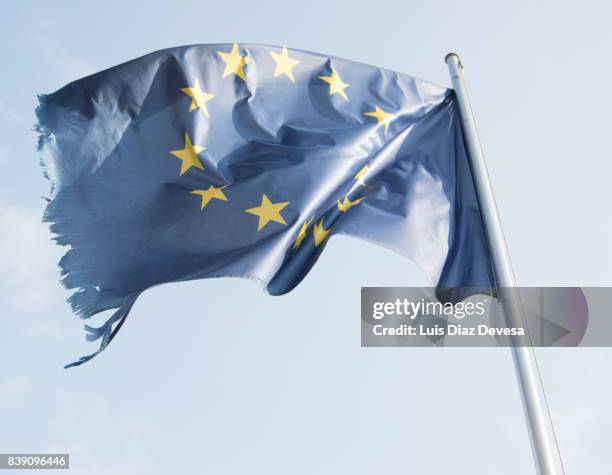 tattered european flag, still flying free and proud - guidelines of cultural politics stock pictures, royalty-free photos & images