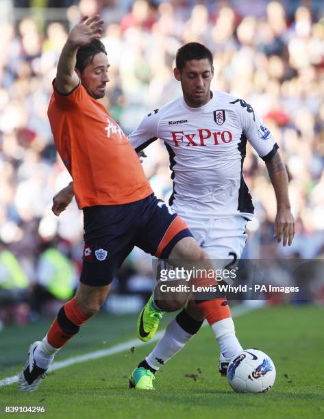 S Tommy Smith passes Fulham's Clint Dempsey during the Barclays Premier League match at Craven Cottage, London.