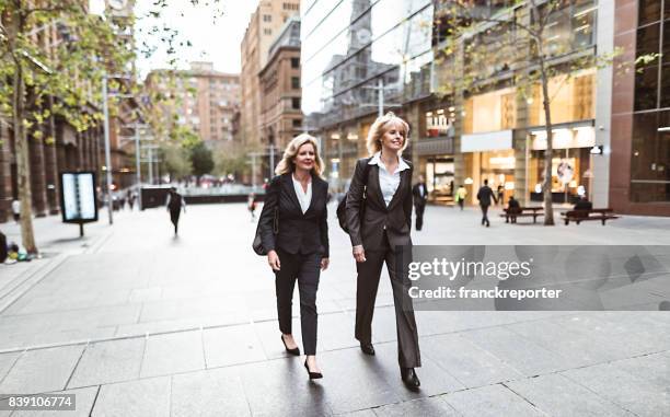 business colleagues walking on the city - 80s business women stock pictures, royalty-free photos & images