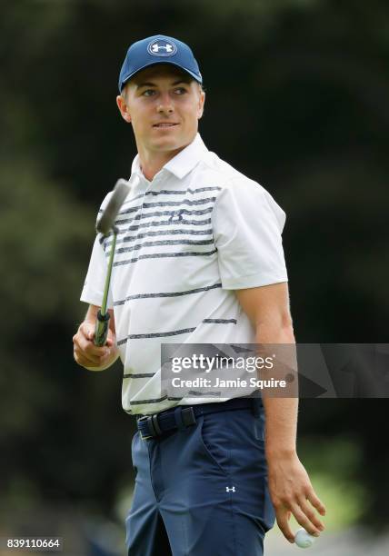 Jordan Spieth of the United States acknowledges fans after putting on the 18th green during round two of The Northern Trust at Glen Oaks Club on...