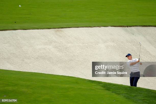 Jordan Spieth of the United States plays a shot from a bunker on the 18th hole during round two of The Northern Trust at Glen Oaks Club on August 25,...