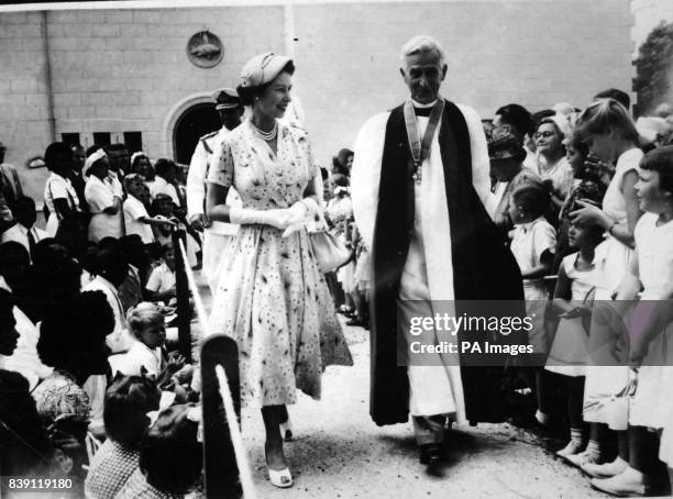 **Scanned low-res from contact** Queen Elizabeth II smiles for the box camera operated by a young girl as she leaves the Anglican Cathedral in Suva,...