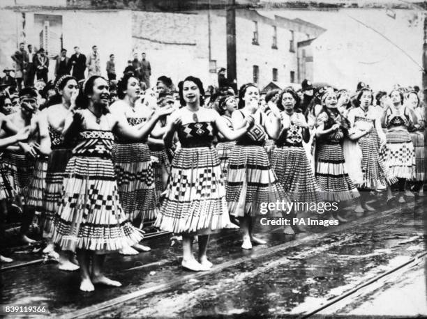 **Scanned low-res from contact** Maori women in colourful dress giving a high-spirited welcomne to the Queen and the Duke of Edinburgh outside the...