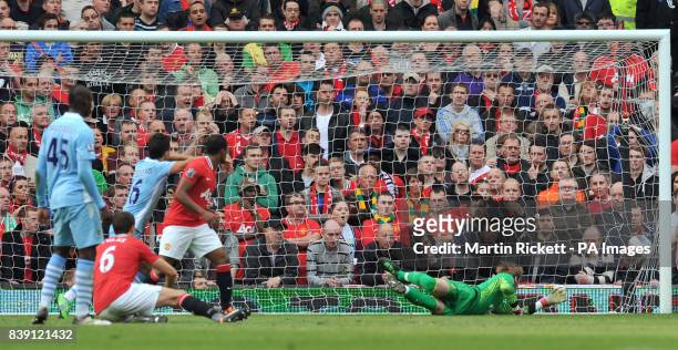 Manchester City's Mario Balotelli scores past Manchester United's goalkeeper David De Gea during the Barclays Premier League match at Old Trafford,...