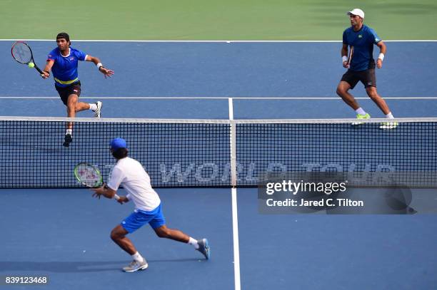 Jean-Julien Rojer of Netherlands and Horia Tecau of Romania return a shot to Horacio Zeballos of Argentina during the men's doubles championship...