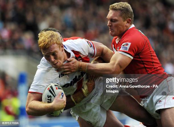 England's Jack Reed scores a try under pressure from Wales' Christian Roets during the Gillette Four Nations match at Leigh Sports Village, Leigh.