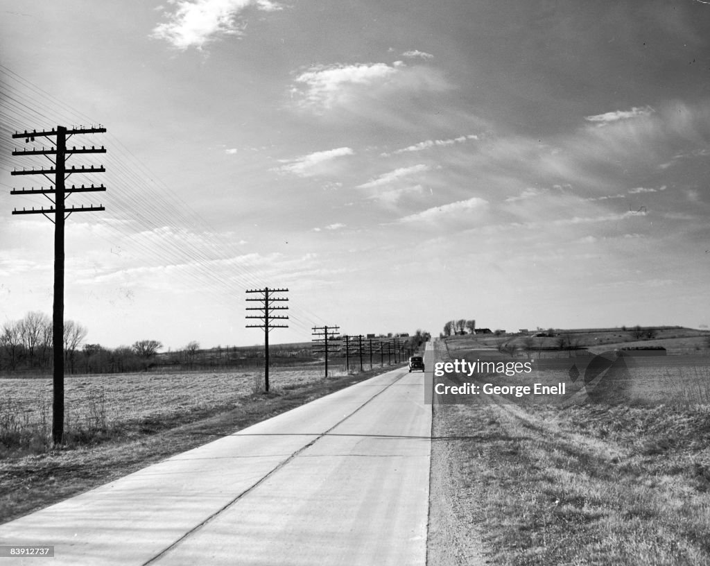 Us Rt40 A car drives along U.S. Route 40 in a rural area in Missouri, 1940s ...