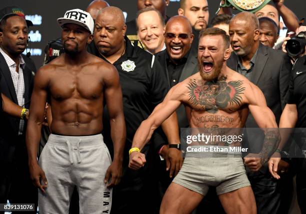 Lightweight champion Conor McGregor screams after the face off with Floyd Mayweather Jr. During their official weigh-in at T-Mobile Arena on August...