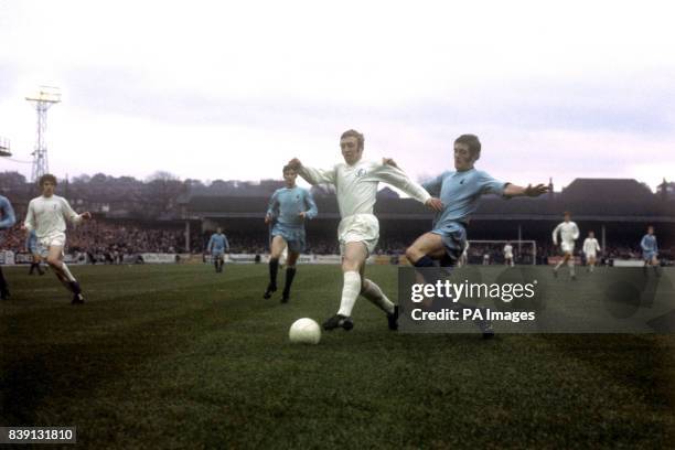 Coventry City's Jeffrey Blockley about to dive in on Leeds United's Mick Jones.