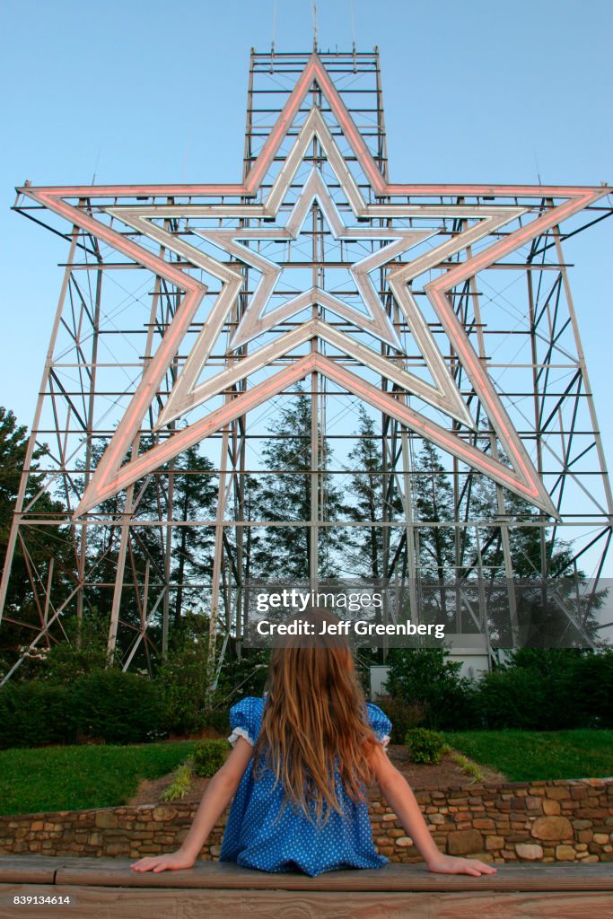 A girl sat looking at Roanoke Star.