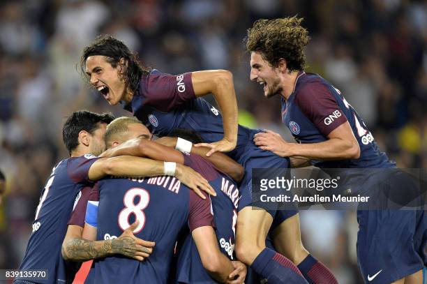Edinson Cavani and Adrien Rabiot of Paris Saint-Germain congratulate Thiago Motta for his goal during the Ligue 1 match between Paris Saint-Germain...