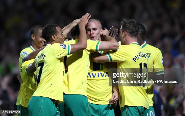 Norwich City's Steve Morison is congratulated by his team mates after he heads home their side's second goal of the game
