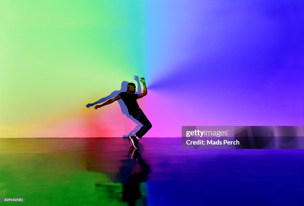 Man Dancing in abstract space with lots of colours around him
