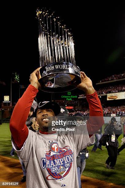 Jimmy Rollins of the Philadelphia Phillies celebrates with the World Series Championship trophy after their 4-3 win against the Tampa Bay Rays during...