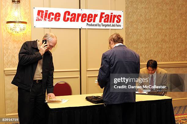 Job seekers wait to speak with prospective employers during a job fair at the Marriot Boston Burlington December 4, 2008 in Burlington,...