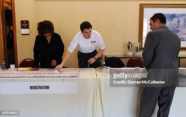Chris Hazlewood and Connie Bowen , of Targeted Job Fairs, set up a registration booth in preparation for a job fair at the Marriot Boston Burlington...