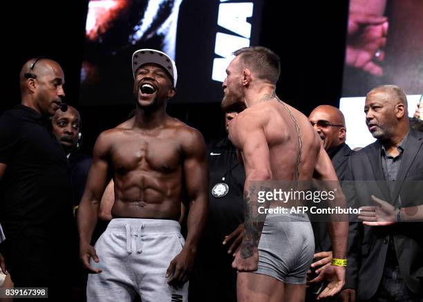 Boxer Floyd Mayweather Jr. And MMA figher Connor Mcgregor pose during their weigh- in on August 25 in Las Vegas, Nevada. Mayweather, the 40-year-old...