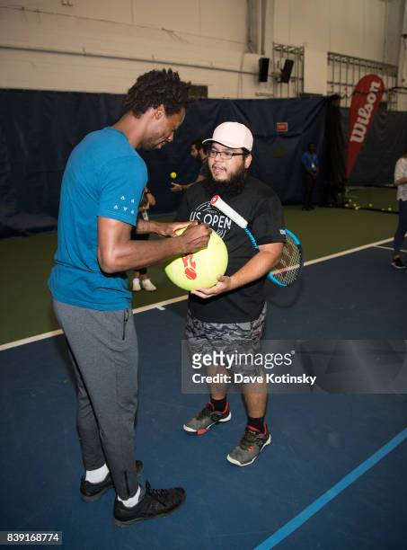 Gael Monfils surprises and join unsuspecting fans for A few games on court fans at Arthur Ashe Stadium on August 25, 2017 in New York City.