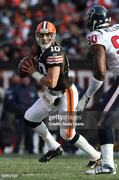 Quarterback Brady Quinn of the Cleveland Browns drops back to pass against Mario Williams of the Houston Texans at Cleveland Browns Stadium on...