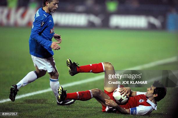 Deportivo La Coruna's captain Juan Carlos Valeron falls down with the ball in front of KKS Lech Poznan's counterpart Rafal Murawski during their UEFA...