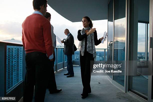 Penni Chasens , master sales associate for Cervera Real Estate, shows a condo to prospective buyer Joe Gambescia at the EPIC Miami Residences and...