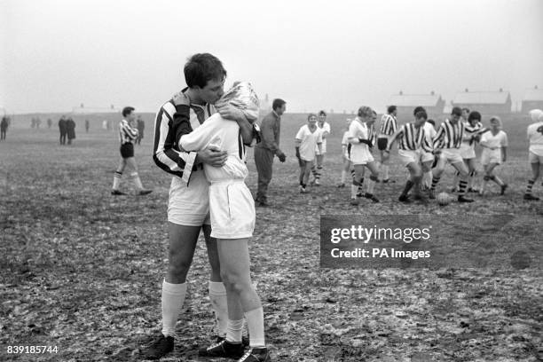 Outside-left Sylvia Watkins temporarily forgets the match as she goes into a kiss and a clinch with opposing right-back George Moore, her fiance. The...