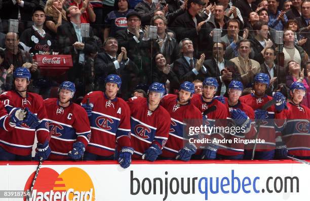 Members of the Montreal Canadiens wait at the bench tro celebrate a first period goal against the New York Rangers wearing vintage jerseys on a night...