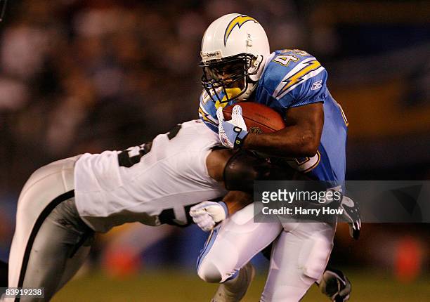 Running Back Darren Sproles is hit by Derrick Burgess of the Oakland Raiders during their NFL Game on December 4, 2008 at Qualcomm Stadium in San...