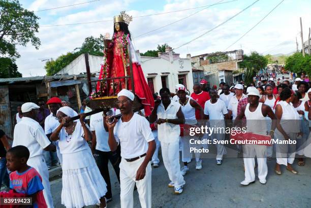 People carry a statue of Saint Barbara as cubans celebrate the anniversary of the Catholic Saint St. Barbara on December 4, 2008 in Santiago de Cuba,...