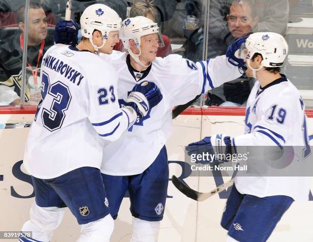 Alexei Ponikarovsky, Jason Blake and Dominic Moore of the Toronto Maple Leafs celebrate a goal against the Phoenix Coyotes on December 4, 2008 at...