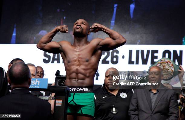 Boxer Floyd Mayweather Jr. Poses during a weigh-in with MMA figher Connor McGregor August 25, 2017 at the T-Mobile Arena in Las Vegas, Nevada....