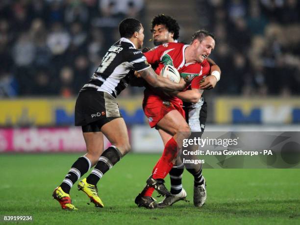 Crusaders' Peter Lupton is tackled by Hull FC's Jordan Turner and Epalahame Lauaki during the Engage Super League match at the KC Stadium, Hull.