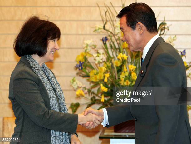 Executive Director of the United Nations Development Fund for Women Ines Alberdi, is greeted by Japanese Prime Minister Taro Aso at the prime...