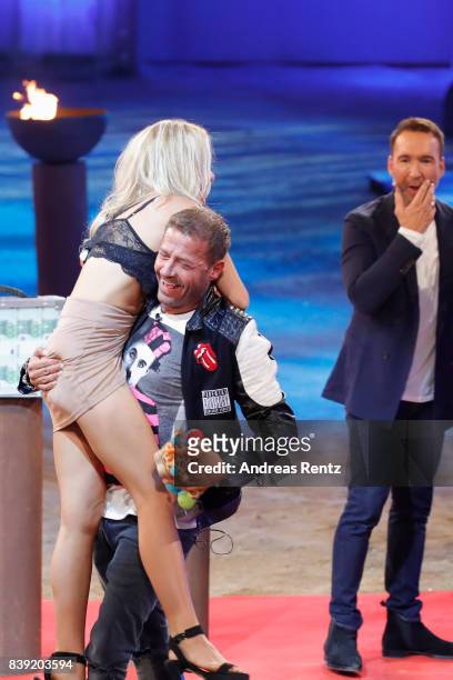 Willi Herren lifts-up Evelyn Burdecki during the finals of 'Promi Big Brother 2017' at MMC Studio on August 25, 2017 in Cologne, Germany.