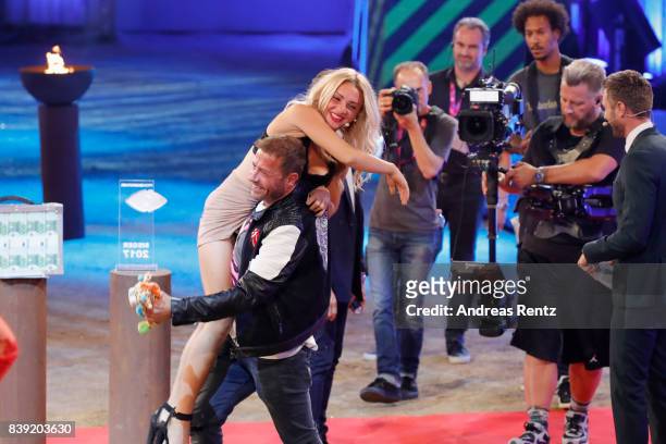 Willi Herren lifts-up Evelyn Burdecki during the finals of 'Promi Big Brother 2017' at MMC Studio on August 25, 2017 in Cologne, Germany.